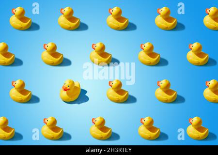 Fashion minimalistic concept of a yellow rubber duck pattern flat lay. Not like everyone else, goes against the system. Stock Photo