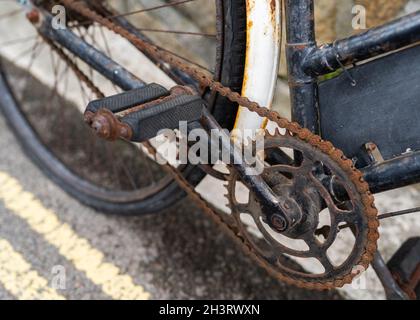 Rusty old bicycle chain in need of oil and maintenance.  Left out to the weather rusted and not working anymore. Stock Photo