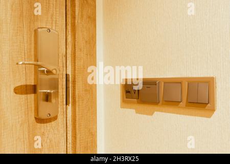 Hotel room interior door handle and lock. Electric, do not disturb and housekeeping buttons on the wall. Stock Photo
