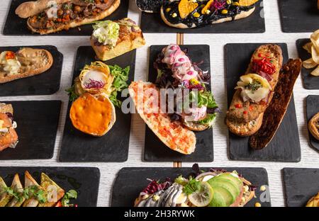 Variety of creative sandwiches on the restaurant table Stock Photo