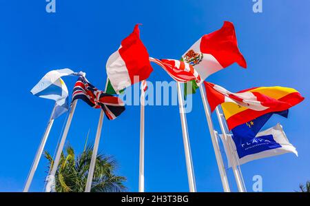 Flags of many countries like argentina spain united states canada italy and europe with blue sky and palm trees in Playa del Carmen Mexico. Stock Photo