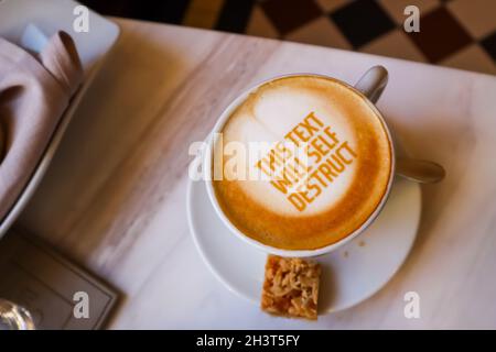 White cup of coffee with text on marble background. Table setting in the restaurant Stock Photo