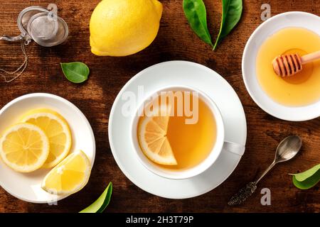 Organic tea with lemons and honey, shot from the top on a rustic background Stock Photo
