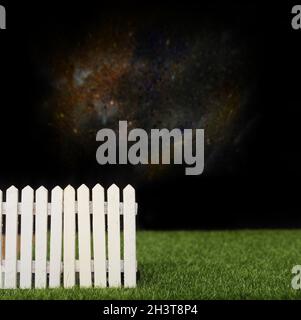 Blue wooden picket fence with blurred green background Stock Photo - Alamy