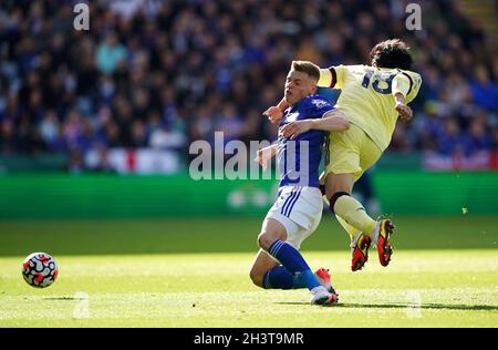 Leicester City's Harvey Barnes (left) and Arsenal's Takehiro Tomiyasu battle for the ball during the Premier League match at the King Power Stadium, Leicester. Picture date: Saturday October 30, 2021. Stock Photo