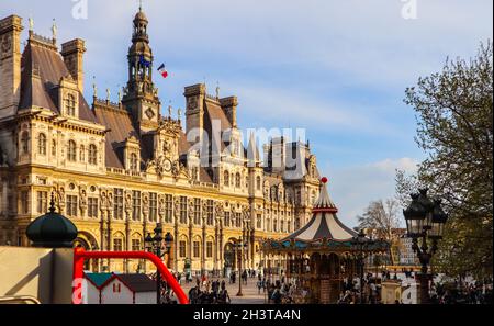 View from the touristic bus on the square in front of Hotel de Ville, the Municipality of Paris, full of resting people at sunse Stock Photo