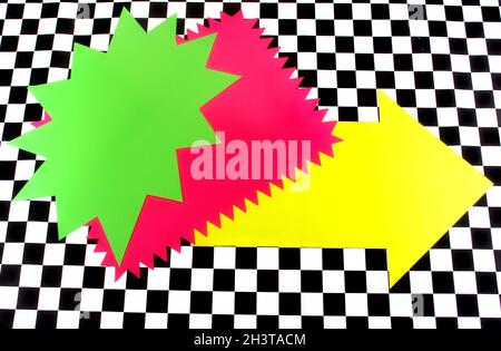 Photograph of Bright Neon Colored Shapes on Black and White Checkerboard Stock Photo