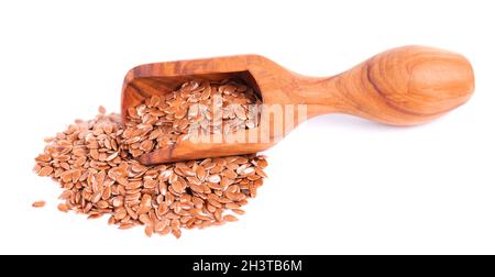 Brown flax seeds in wooden scoop, isolated on white background. Heap of dry flaxseed or linseed. Stock Photo