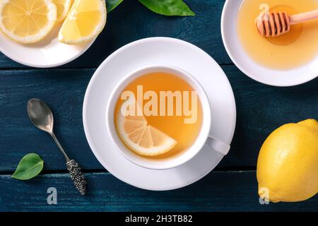 A cup of lemon tea with honey, shot from the top on a dark wooden background Stock Photo