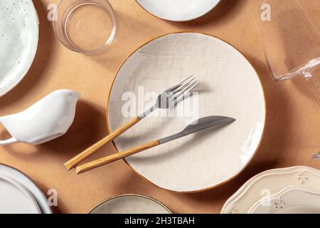 Modern tableware, overhead flat lay shot. Trendy plates, glasses, and cutlery Stock Photo