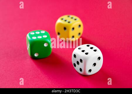 Three colorful dices isolated on pink background Stock Photo