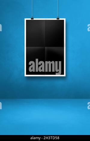 Black folded poster hanging on a blue wall with clips Stock Photo