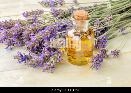 Lavender essential oil with a bouquet of flowers, toned image Stock Photo