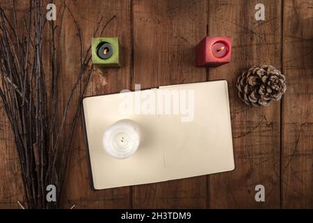 Overhead photo of open grimoire, candles, and a broom Stock Photo