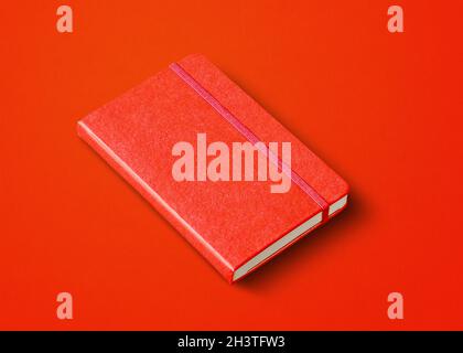 Red closed notebook isolated on color background Stock Photo