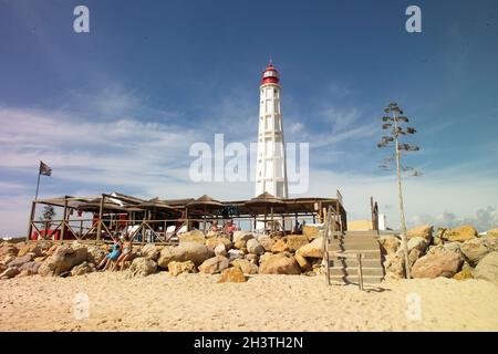 Lighthouse on Farol Island, Algarve - Portugal Stock Photo