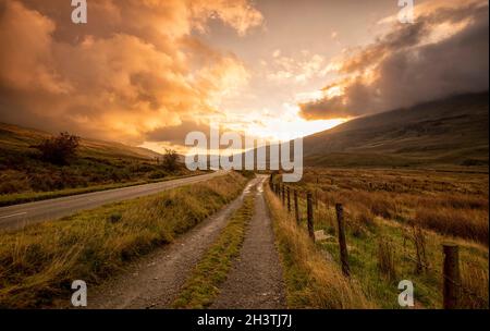 Sunrise on the A4086 between Capel Curig and Pen-y-Pass in Snowdonia National Park, Wales UK Stock Photo