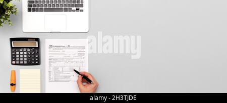 Tax income concept with US tax form. Documents on desk, top view Stock Photo
