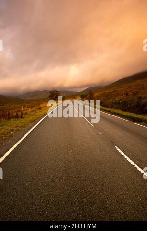 Sunrise on the A4086 between Capel Curig and Pen-y-Pass in Snowdonia National Park, Wales UK Stock Photo