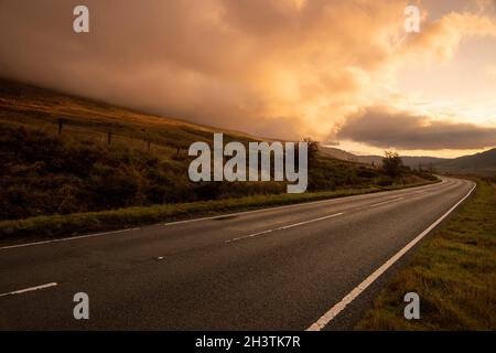 Sunrise on the A4086 between Capel Curig and Pen-y-Pass in Snowdonia National Park, Wales UK Stock Photo