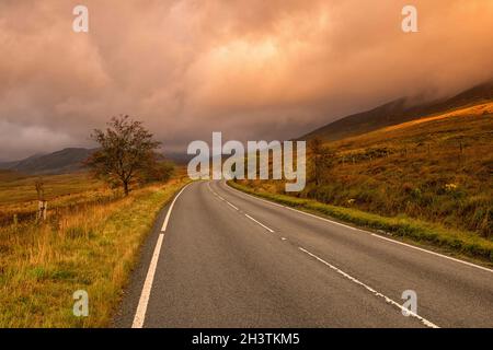 Sunrise on the A4086 between Capel Curig and Pen-y-Pass in Snowdonia National Park, Wales UK Stock Photo