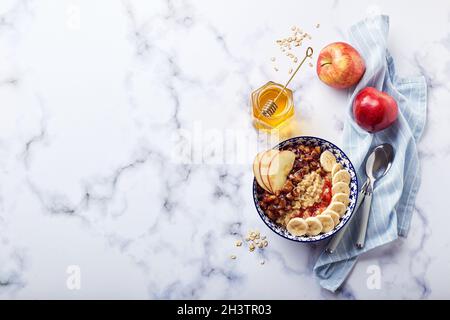 Homemade oatmeal for breakfast with apple, cinnamon and honey Stock Photo