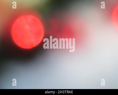 Defocused bokeh lights for backdrop. Red circles of light. Abstract and Christmas background. Stock Photo