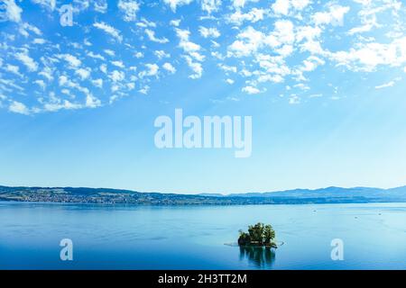Lake Zurich in Wollerau, canton of Schwyz in Switzerland, Zurichsee, Swiss mountains landscape, blue water and sky in summer, id Stock Photo
