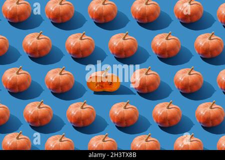 Pattern of pumpkins on a blue background. Autumn harvest. Pumpkin. Thanksgiving Day. Food for Halloween. Stock Photo