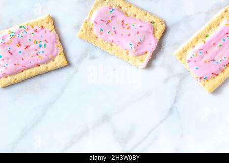 Pink pop tarts, shot from the top on a white marble background Stock Photo