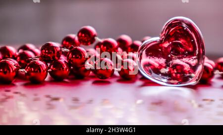 Shining transparent heart and beads. Perfect Valentine's Day greeting card background. Horizontal image in pink tone Stock Photo