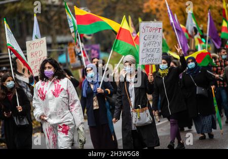 Stuttgart, Germany. 30th Oct, 2021. Supporters of the Kurds walk through downtown Stuttgart during a demonstration. A woman carries a placard with the inscription 'Stop Turkey's use of chemical weapons'. They are demonstrating against the Turkish military deployment in northern Iraq. Credit: Christoph Schmidt/dpa/Alamy Live News Stock Photo