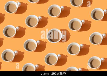 Coffee cups on orange background. Creative concept idea made of coffee. Coffee break time. Top view. Flat lay. Stock Photo