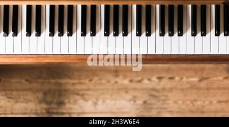 Vintage wooden piano keys, wooden blurry floor Stock Photo