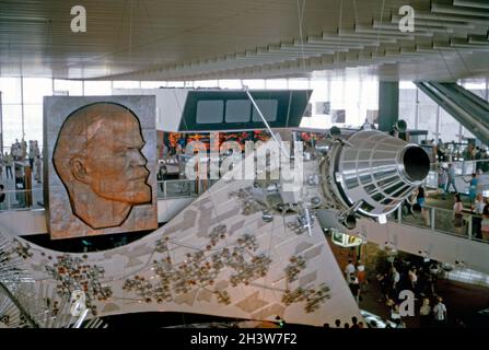 The USSR pavilion (Soviet Union, URSS or Moscow Pavilion) at Expo 67, Montreal, Quebec, Canada in 1967. It was designed by a team of architects led by Mikhail Posokhin. Amongst the interior displays in the steel and glass pavilion were a relief sculpture of Lenin (left), a sputnik (right) and a giant electronic circuit board. The attraction lived on after 1967 during summer months and finally closed in 1981. This image is from an old amateur Kodak colour transparency taken by a visitor to the fair – a vintage 1960s photograph. Stock Photo