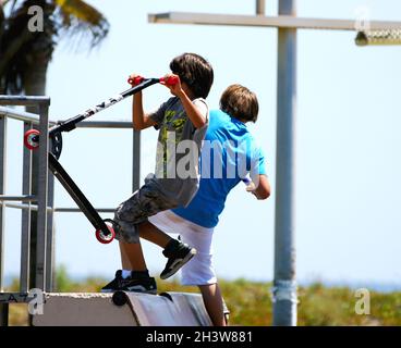 Children with skateboard in a park in Castelldefels, Barcelona, Catalunya, Spain, Europe Stock Photo