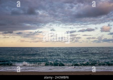 sea. waves at beach small clouds at sunset. horizontal Stock Photo
