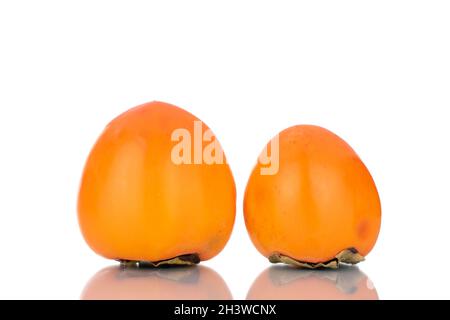 Two ripe sweet persimmons, close-up, isolated on white. Stock Photo