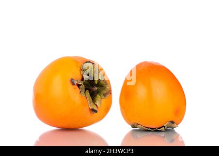 Two ripe sweet persimmons, close-up, isolated on white. Stock Photo