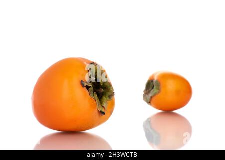 Two ripe sweet persimmons, close-up, isolated on white. Stock Photo