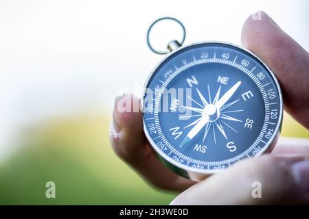 Compass holding in the hand, outdoor adventure Stock Photo