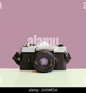 Vintage photography camera on red colored background, retro Stock Photo