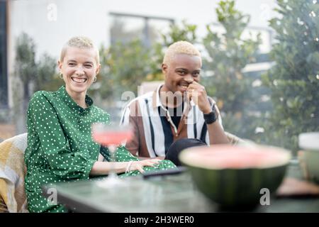 Multiracial couple having dinner at their backyard Stock Photo