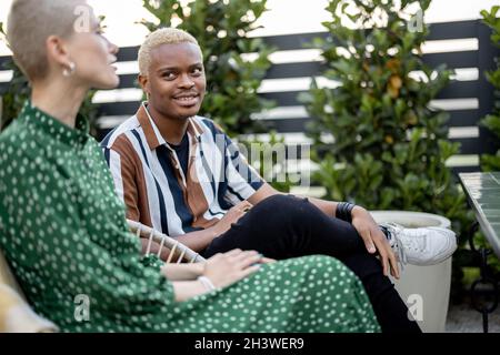 Multiracial couple having dinner at their backyard Stock Photo