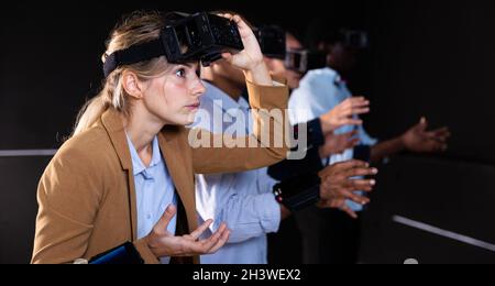 Woman using virtual reality headset and gesturing Stock Photo