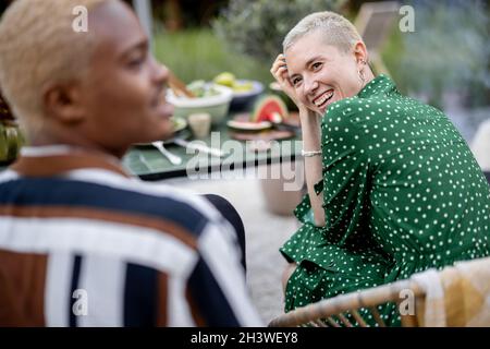 Multiracial couple having dinner at their backyard Stock Photo