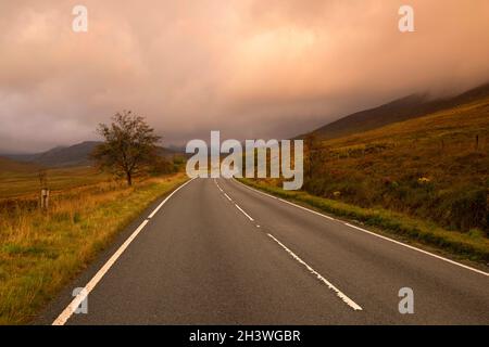 Sunrise on the A4086 between Capel Curig and Pen-y-Pass in Snowdonia National Park, Wales UK Stock Photo