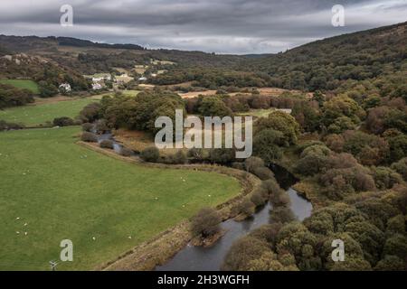 Epic aerial flying drone landscape image towards Crimpiau viewed from above Llynau Mymber during Autumn sunset Stock Photo