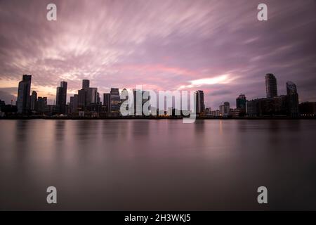 Dusk at Canary Wharf, captured from the Greenwich Peninsula in London, England UK Stock Photo