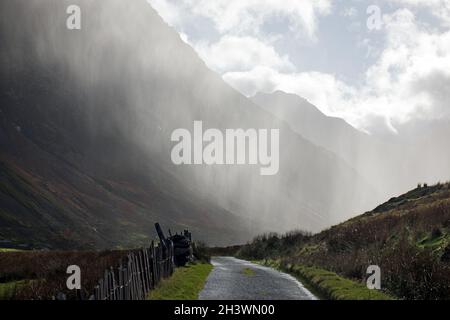 Shown here is a heavy downpour in Nant Ffrancon (Ogwen Valley) in Snowdonia, North Wales. Stock Photo
